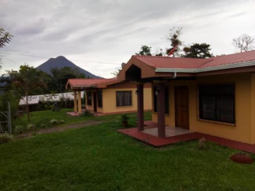 a house with a mountain in the background at Casas de Campo Las Pavitas Cottages "Red Frog" in Palma