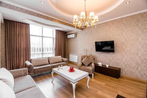 Dat Exx Apartments في تبليسي: غرفة معيشة مع أريكة وطاولة