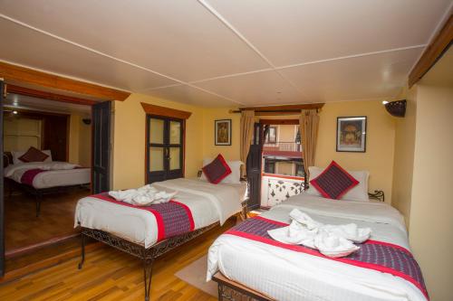 a bedroom with two beds with towels on them at Kathmandu Boutique Hotel in Kathmandu