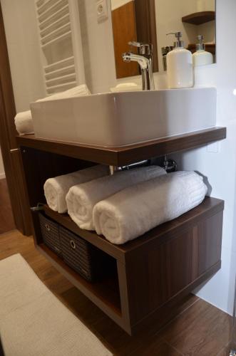 a bathroom with a sink and towels under it at Primo Maxi in Starý Smokovec