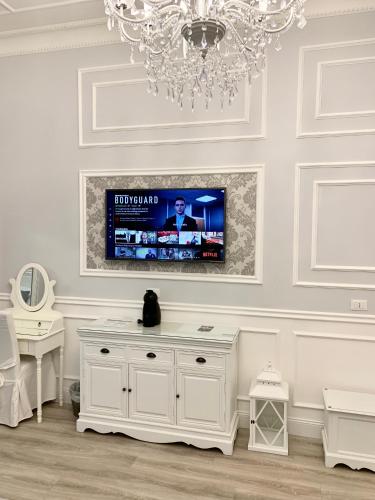 a white room with a television on a wall at Charme & Chic Luxury in Rome