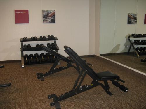 a gym with a chair and a row of dumbbells at MainStay Suites Coeur d'Alene in Coeur d'Alene