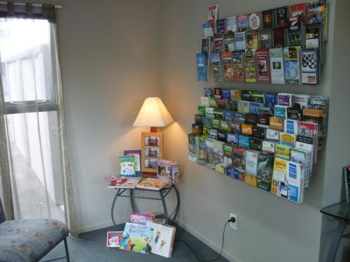 a room with a lamp and books on a wall at Chancellor Motor Lodge and Conference Centre in Palmerston North