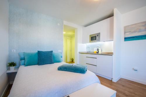 a bedroom with a large bed with blue pillows at Esmeralda, Pet Friendly, Sea View, Wifi, Near the Beach in La Cala de Mijas