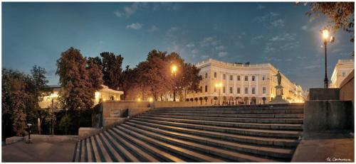a set of stairs in front of a white building at Rose d'Opera Hotel in Odesa