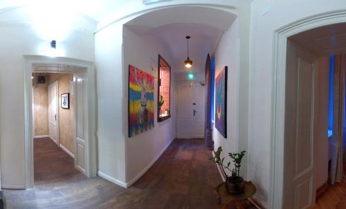 a hallway with paintings on the walls of a home at Zagreb Speeka in Zagreb