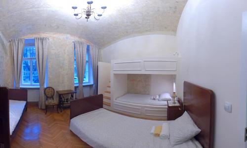 a bedroom with two beds and a chandelier at Zagreb Speeka in Zagreb