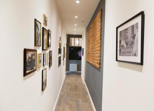 a hallway with framed pictures on the walls at Zagreb Speeka in Zagreb
