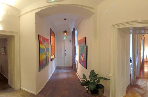 a hallway of a home with paintings on the walls at Zagreb Speeka in Zagreb