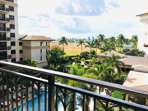 a view of the pool from the balcony of a resort at Beach Villas at Ko Olina 5th floor Ocean View in Kapolei