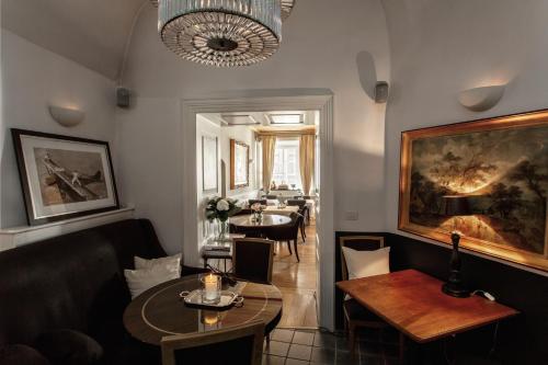 a living room with a couch and a table at Lesar Hotel Angel - Member of Hip Hotels in Ljubljana