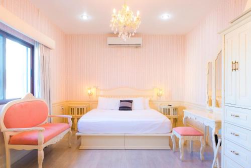 a bedroom with a bed and a desk and a chair at Casa Barco Hotel Boutique in Isla Mujeres