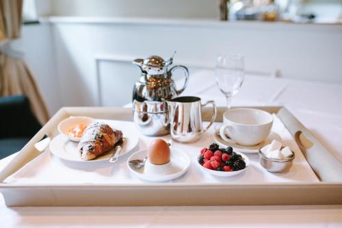 a tray with breakfast foods on a table at Lesar Hotel Angel - Member of Hip Hotels in Ljubljana