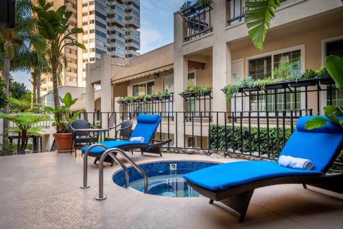 a patio with chairs and a small pool at Beverly Hills Plaza Hotel & Spa in Los Angeles