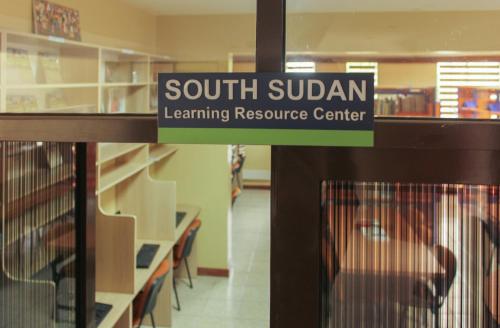 a sign for a south sudan learning resource center in a store at LIA Hotel & Training Centre in Nairobi