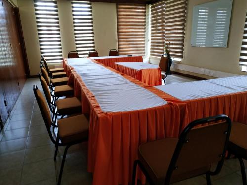 a row of tables and chairs in a room with windows at LIA Hotel & Training Centre in Nairobi