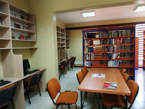 a library with a table and chairs and bookshelves at LIA Hotel & Training Centre in Nairobi