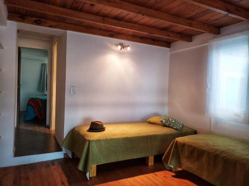 a bedroom with a bed with a hat on it at Medanos in Las Gaviotas