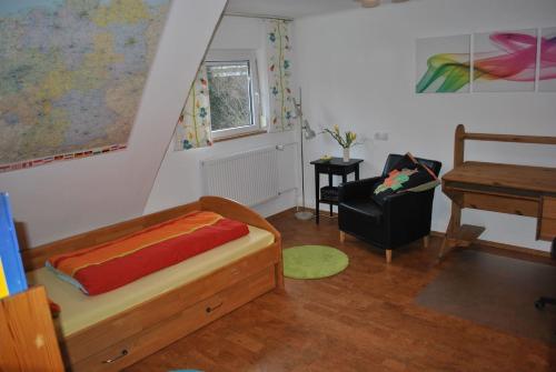 a bedroom with a bed and a table and a piano at Ferienwohnung Giessl in Giengen an der Brenz