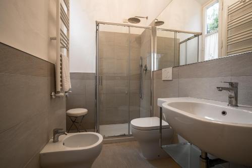 a bathroom with a sink and a toilet and a shower at Hotel Villa Maremonti in Marina di Massa