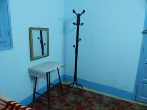 a blue room with a table and a mirror at Bob Marley House Sherief Hotel Luxor in Luxor