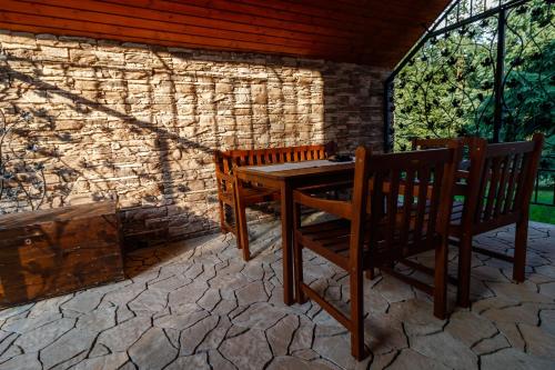 a wooden table and two chairs on a patio at Chata Lienka in Lazisko