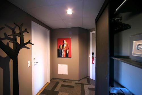 a hallway with a picture of a tree on the wall at Hotel Lautrup Park in Ballerup