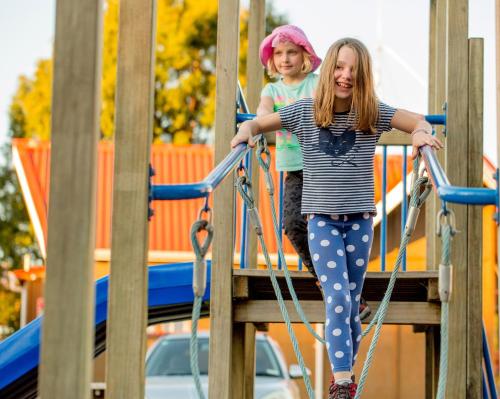 two young girls playing on a playground at Ohakune TOP 10 Holiday Park in Ohakune