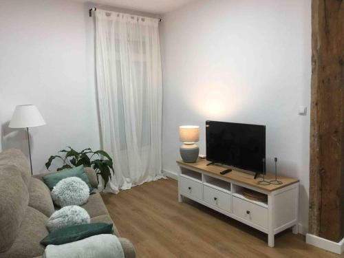 un salon avec une télévision à écran plat sur une table dans l'établissement El Botxito, à Bilbao