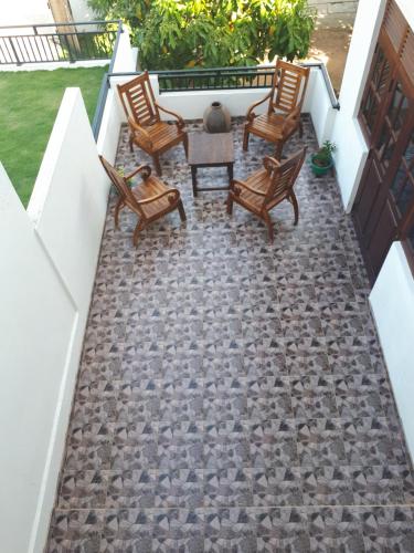 a patio with chairs and a table on a balcony at Lake View Villa in Mirissa