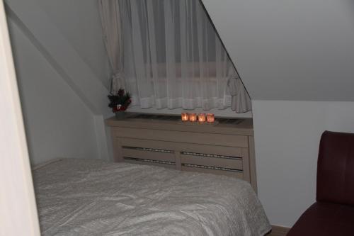 a bedroom with a bed and a window with candles at Kopaonik011 Konaci&WoodSide Apartments in Kopaonik