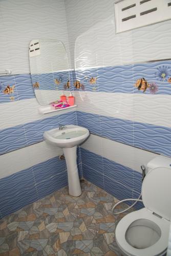 a bathroom with a toilet and a sink at Baan Sea Cream in Haad Chao Samran