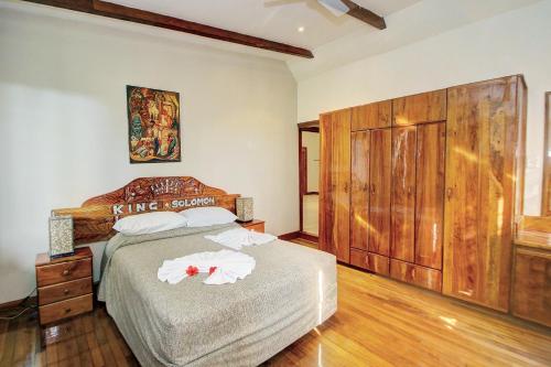 a bedroom with a bed with two towels on it at King Solomon Hotel in Honiara