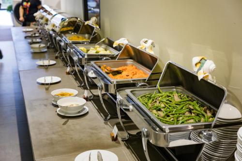 a buffet line of trays of food on a table at TUI BLUE Nha Trang in Nha Trang