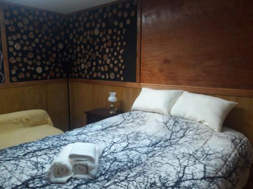 a bedroom with a bed with two donuts on it at Casa de Campo A Pasos De La Ciudad in Punta Arenas