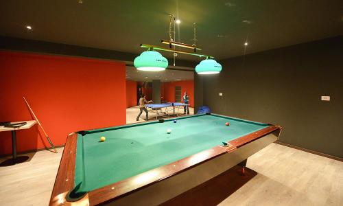 a billiard room with a pool table in it at Hotel Escalade in Poiana Brasov