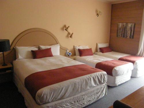 a hotel room with two beds in a room at Quality Inn Colonial in Bendigo