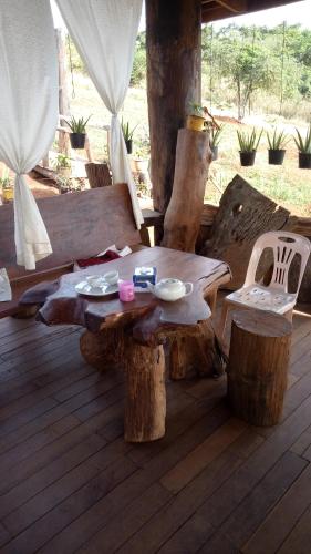 a wooden table and chairs on a wooden deck at Ratanak Tep Rithea homestay in Banlung