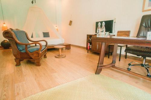 an office with a desk and a computer and a chair at iRoHa Garden Hotel & Resort in Phnom Penh