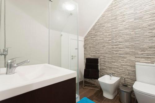 a bathroom with a sink and a toilet at Studios of the Panteão, 0th floor in Lisbon