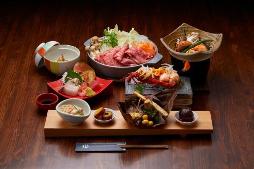 a table topped with different types of food on a table at Yawaragi-no-Sato Yadoya in Yufuin