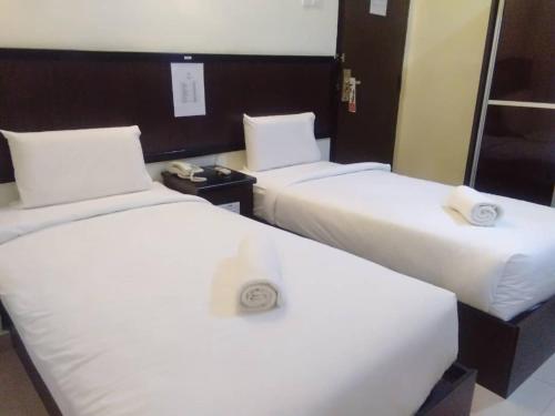 Postel nebo postele na pokoji v ubytování Hotel Mewah Impiana