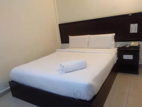 Postel nebo postele na pokoji v ubytování Hotel Mewah Impiana