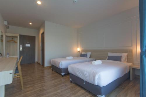 Ένα ή περισσότερα κρεβάτια σε δωμάτιο στο Donchan Grand Hotel