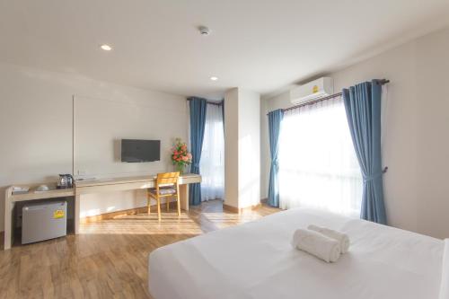 Ένα ή περισσότερα κρεβάτια σε δωμάτιο στο Donchan Grand Hotel