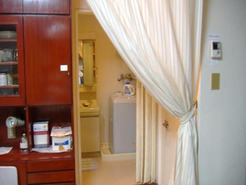 a room with a door with a curtain and a mirror at Special Honmachi in Okayama