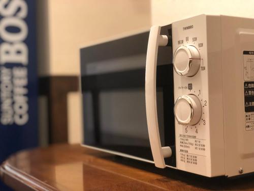 a microwave oven sitting on top of a table at Hotel Karuizawa Elegance in Karuizawa