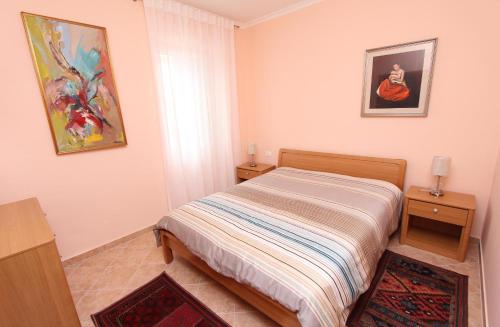 a small bedroom with a bed and two night stands at Apartments Casa Menis in Rovinj