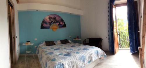 a bedroom with a bed and a blue wall at La Perla del Sud in Teulada