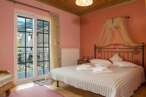 a bedroom with a bed with towels on it at Guesthouse To Tzaki, in Konitsa